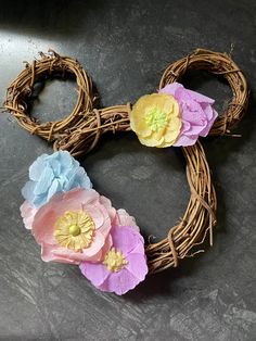 three paper flowers are placed in the shape of a heart