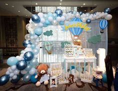 a baby shower with balloons and teddy bears