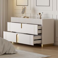 a white dresser with two drawers and a mirror on it's side, next to a bed