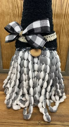 a black and white doll wearing a hat