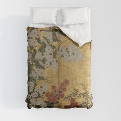 an image of a bed with flowers on the comforter and pillow cases in it