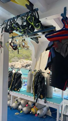 the inside of a boat with scuba gear and equipment hanging from it's ceiling