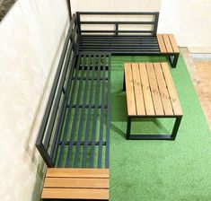 two wooden benches sitting next to each other on top of green carpeted flooring