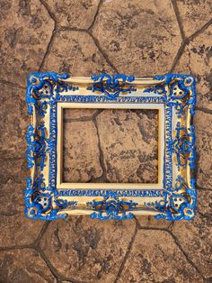 a blue and gold frame sitting on the ground