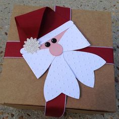 an origami santa clause on top of a brown box