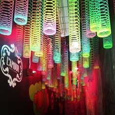 an iphone photo with neon lights hanging from it