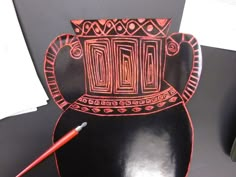 a black and red paper cut out of a vase