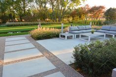 an outdoor seating area with couches and tables