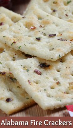 some crackers that are sitting on a wooden board with the words, alabama fire crackers