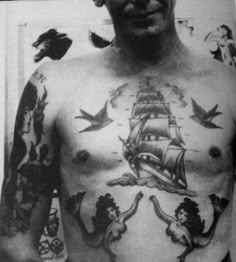 a man with many tattoos on his chest