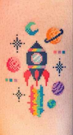 the back of a woman's stomach with pixelated space and rockets on it