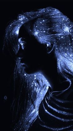 a woman with long hair and stars on her face is shown in the dark sky