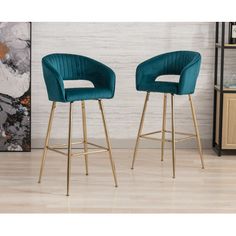 two blue velvet bar stools with gold legs