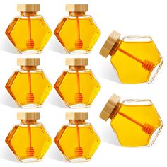 six honey bottles with a wooden stick in them