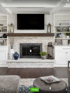 a living room filled with furniture and a flat screen tv mounted above a fire place