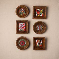 four wooden plates with colorful designs on them