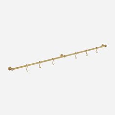 a gold coat rack with three hooks on the end and an umbrella hook attached to it