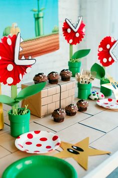 a table topped with lots of cupcakes and cake