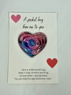 there is a card with a heart shaped object in the shape of a pink and blue heart