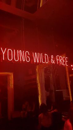 a neon sign that reads young, wild and free