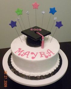 a graduation cake with stars and a mortar on top