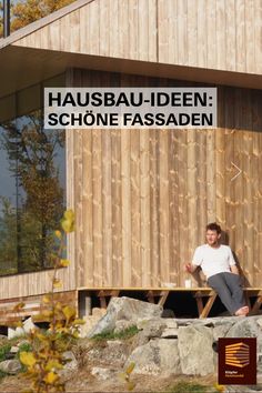 a man sitting on a bench in front of a wooden building with the words hausbau - ideen schone fassaden