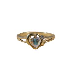 "This is a beautiful vintage anniversary ring made from 10k yellow gold and a heart-shaped white topaz stone. The topaz stone is 6mm x 4mm and roughly .85 cts. There is a tiny diamond chip on the top right side of the ring. The setting is heart shaped, with a cut out between the setting and the stone. This is a gorgeous ring, great as a promise ring, anniversary ring or Valentines Day present.  This ring is sweet, classic and romantic.   | MEASUREMENTS | Length: 3/4\" Width: 1/2\" Ring Size: 7 Weight: 2g | DETAILS | Era: 1980s Style: Solitaire with accents Material: 10k yellow gold, white topaz and a diamond Colors: Yellow, Gold, Purple, White, Clear Condition: Excellent All jewelry is cleaned and stored in a smoke-free home." Vintage Anniversary Rings, Vintage Anniversary, 1980s Style, Vintage Gold Rings, 10k Gold Ring, Diamond Accent Ring, Yellow Gold Diamond Ring, Gorgeous Ring, Etsy Gold Ring