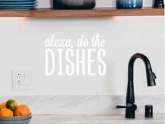 a kitchen wall with the words alexa, do the dishes written in cursive font