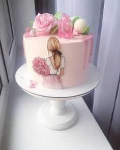 a pink cake decorated with flowers and the number ten on it is sitting on a white pedestal