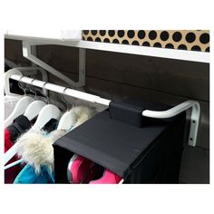 a rack with several pairs of shoes hanging from it's sides and two bins on the other side