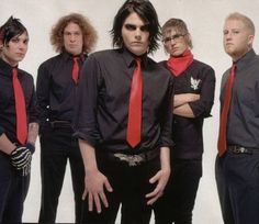 a group of young men wearing red ties and black shirts, standing in front of a white background