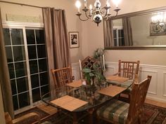 a dining room table with chairs and a chandelier