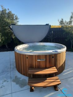 an outdoor hot tub with steps leading up to it