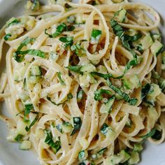 a white bowl filled with pasta and vegetables