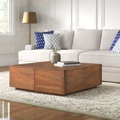 a living room with a white couch and wooden coffee table