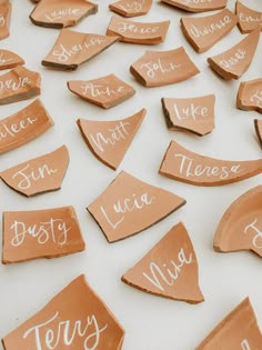 several pieces of clay that have been cut into small shapes with words written on them