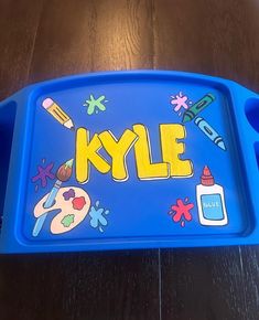 a blue tray with the word kyle painted on it