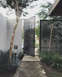 an entrance to a house with black iron gates