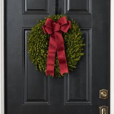 a black door with a red bow on it