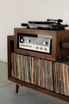 an old record player is sitting on top of a cabinet