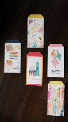 four different greeting cards on a wooden table