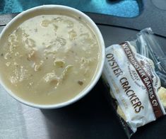 a bowl of soup next to some crackers