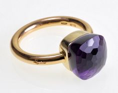 The Pomellato Nudo 18K Gold Amethyst Italy Ring Size 6  is a stunning and unique piece of jewelry. The ring is simple in design,  but the beauty of the gemstone is truly breathtaking. Pomellato is an Italian jewelry company that is known  for its high-quality and innovative designs.  The Nudo collection is one of Pomellato's most popular collections,  and it is known for its bold and colorful gemstones. The checker faceted top of the amethyst gemstone measures 10.5 mm square. The face of the rin Elegant Faceted Amethyst Ring In Yellow Gold, Luxury Faceted Amethyst Ring For Formal Occasions, Luxury Faceted Amethyst Ring For Formal Events, Luxury 14k Gold Amethyst Ring, Colorful Gemstones, Thistle Flower, Fine Gold Jewelry, Italian Jewelry, Jewelry Companies