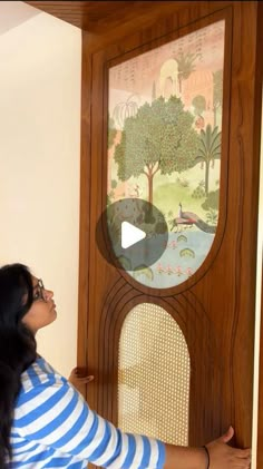 a woman standing in front of a grandfather clock