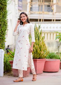 Off-white printed straight calf length kurta, has a keyhole neck, three-quarter sleeves, straight hem, side slits. Off-white printed trousers, has partially elasticated waistband, slip-on closure.   Size  & Fit:  The model (height 5'8") is wearing a size S.   Material & Care: Top fabric: 100% Cotton Bottom fabric: Cotton Blend Hand-wash   US Size Conversion: XS = 0, S = 2-4, M = 6-8, L = 10, XL = 12-14, XXL = 16, XXXL = 18 Size Guide in inches (garment measurements): Sizes, US Sizes, Bust, Waist Designer Kurtis Online, Resort Chic, Kurti Sets, Punjabi Dress, White Kurta, Kurta Design, Keyhole Neck, Set Style, Printed Trousers