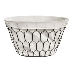 a white and black basket with hexagonal design on the sides, sitting in front of a white background