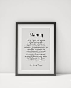 a framed print with the words nammy in black and white, on a shelf