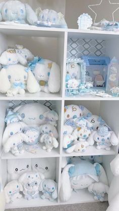 the shelves are filled with stuffed animals and other items in blue, white and gold colors