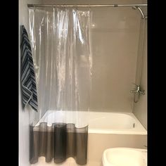 a white bath tub sitting next to a shower curtain