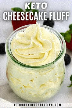 keto cheesecake fluff in a glass jar with berries around it